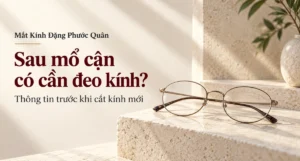 Ảnh bìa cặp kính gọng kim loại mảnh đặt trên bậc đá sáng cho bài về việc đeo kính sau mổ cận